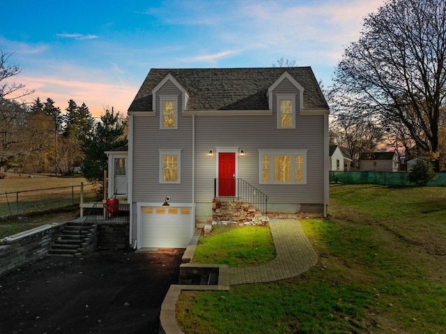 view of front of house with a yard and a garage