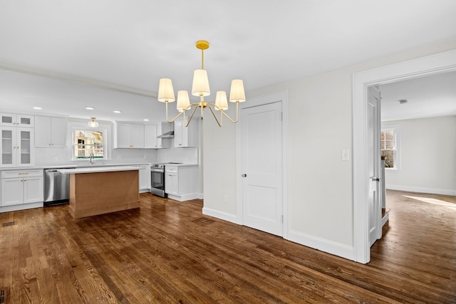 kitchen with stainless steel appliances, pendant lighting, a center island, dark hardwood / wood-style floors, and white cabinetry