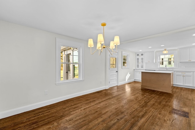 interior space with sink, dark hardwood / wood-style floors, and a notable chandelier