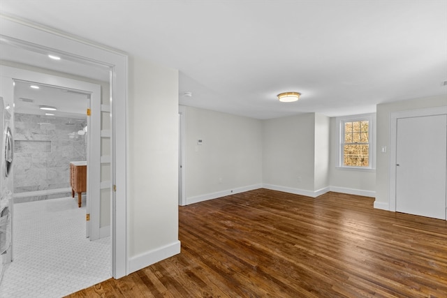 spare room featuring dark wood-type flooring