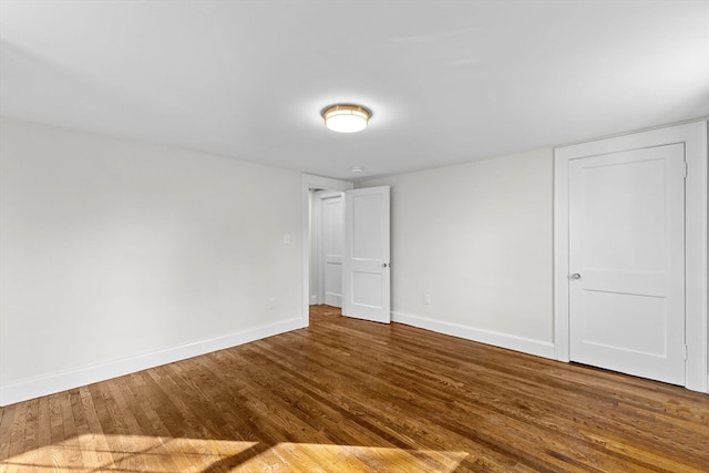 unfurnished room with hardwood / wood-style floors