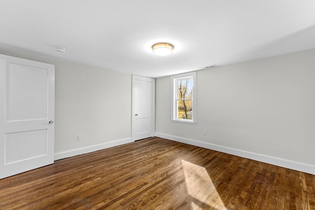 unfurnished room with hardwood / wood-style floors