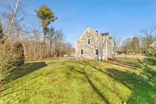 rear view of house featuring a yard