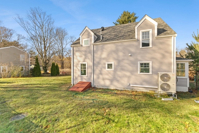 back of property featuring a lawn