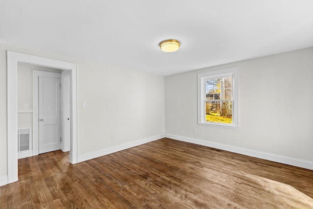 unfurnished room with dark hardwood / wood-style floors