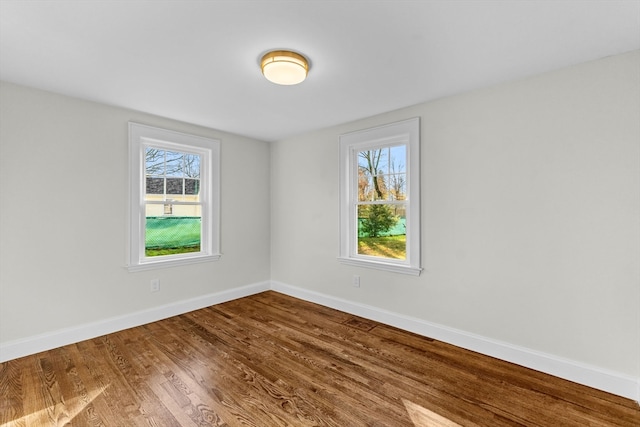 unfurnished room with hardwood / wood-style flooring