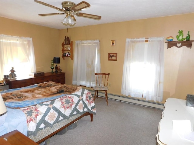 bedroom featuring a baseboard heating unit, carpet floors, and ceiling fan