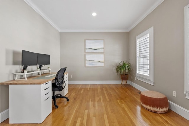 office with light wood-type flooring, baseboards, and crown molding