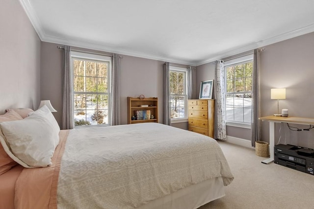 carpeted bedroom featuring baseboards and crown molding