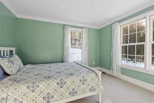 carpeted bedroom with baseboards and ornamental molding