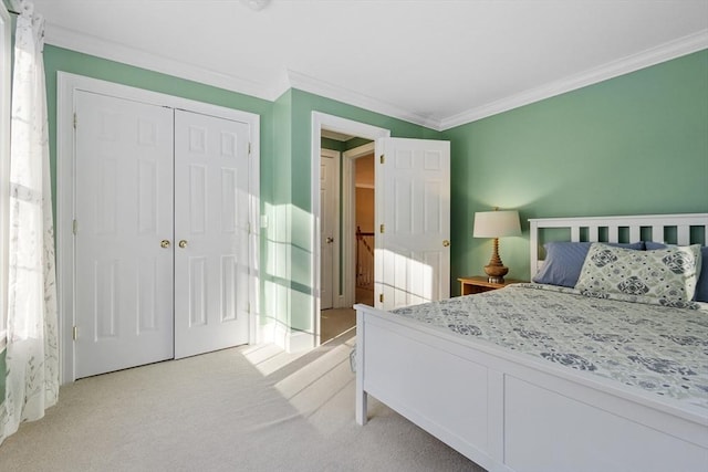 bedroom featuring ornamental molding, a closet, and light colored carpet