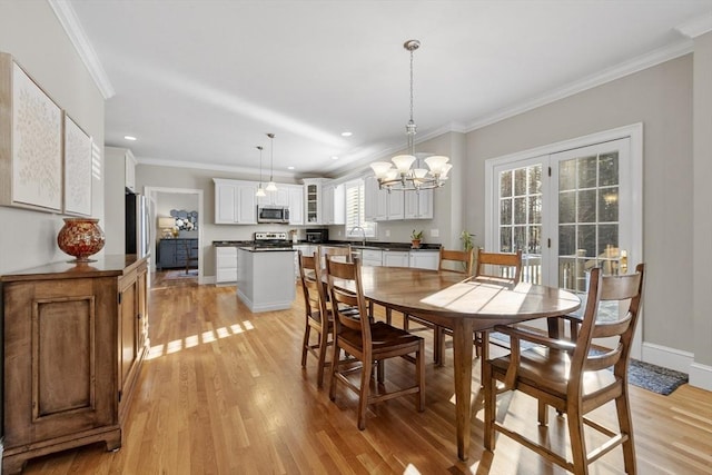 dining room featuring recessed lighting, baseboards, french doors, light wood-type flooring, and crown molding