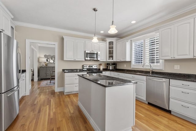 kitchen featuring light wood-type flooring, appliances with stainless steel finishes, and white cabinets