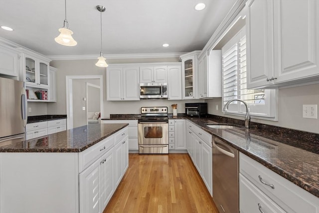 kitchen with white cabinetry, appliances with stainless steel finishes, and a sink