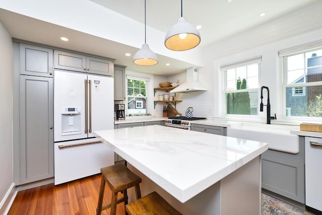 15 N Pleasant, Dartmouth, MA 02748 - kitchen with high end appliances, gray cabinets, custom exhaust hood, wood finished floors, and recessed lighting
