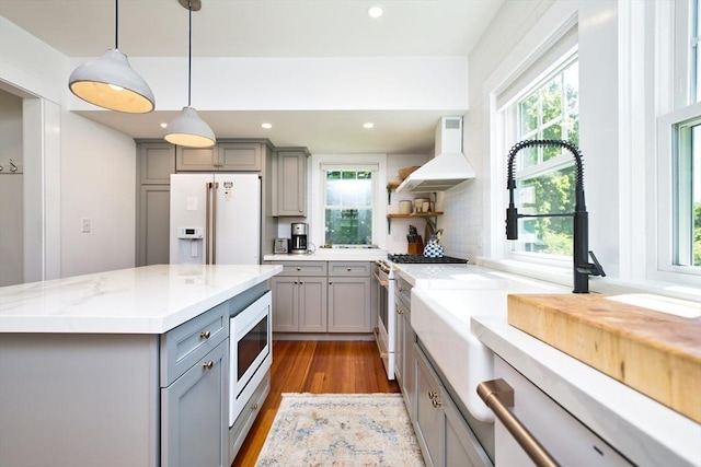 15 N Pleasant, Dartmouth, MA 02748 - kitchen with gray cabinets, premium range hood, white appliances, healthy amount of natural light, and recessed lighting