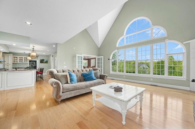 15 Keyes House Rd, Shrewsbury, MA 01545 - living area with high vaulted ceiling, light wood-type flooring, recessed lighting, and baseboards