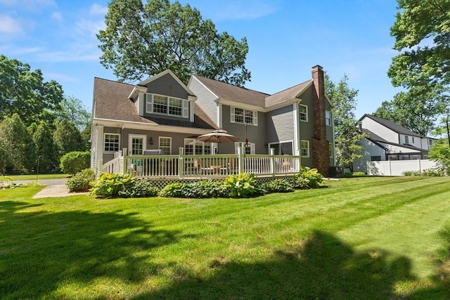 1 Burnham Ln, Danvers, MA 01923 - back of house with a chimney, a deck, and a lawn