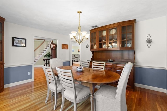 1 Burnham Ln, Danvers, MA 01923 - dining area with stairs, light wood-style floors, and a chandelier