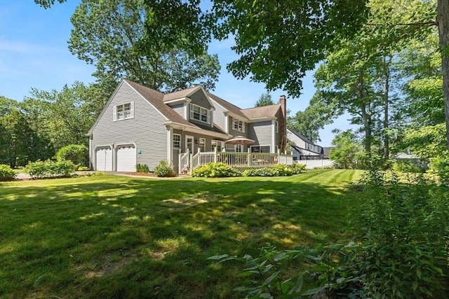 1 Burnham Ln, Danvers, MA 01923 - rear view of house with an attached garage, a wooden deck, a chimney, and a lawn