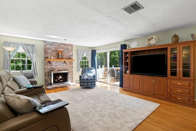 1 Burnham Ln, Danvers, MA 01923 - living area with light wood-style flooring, plenty of natural light, and a fireplace