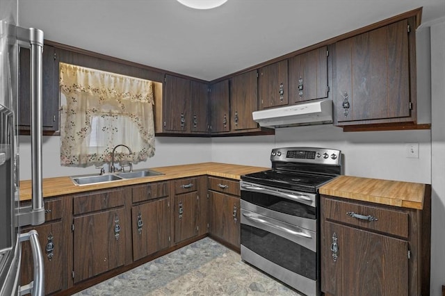 kitchen featuring under cabinet range hood, dark brown cabinetry, double oven range, and a sink