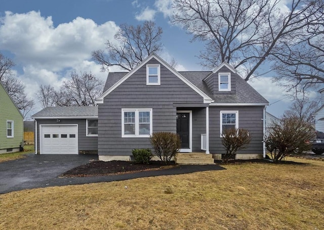 new england style home with a front yard and a garage