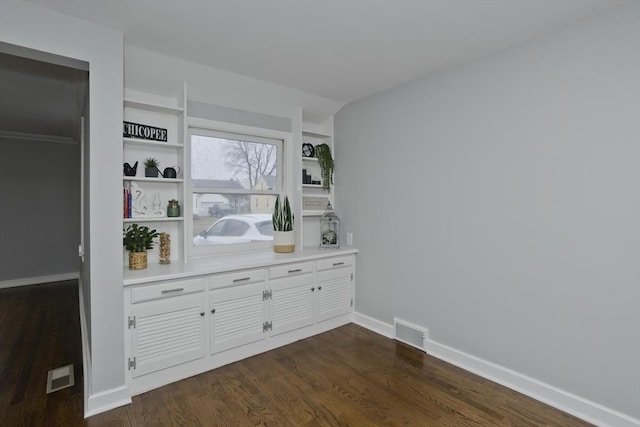 bar featuring white cabinets, built in shelves, and dark hardwood / wood-style floors