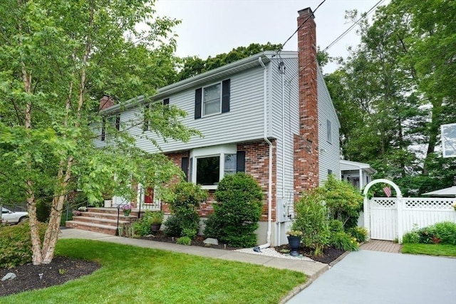 113 Edgehill Rd Unit 113, Norwood, MA 02062 - view of front of property with a chimney, brick siding, and a gate