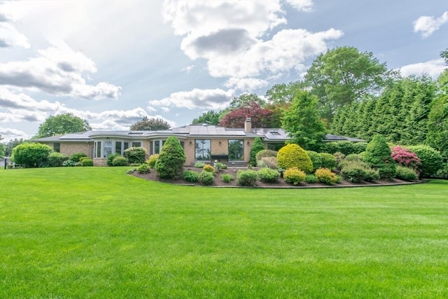 109 Wild Grove Ln, Longmeadow, MA 01106 - view of front of property featuring a front lawn, a chimney, and brick siding