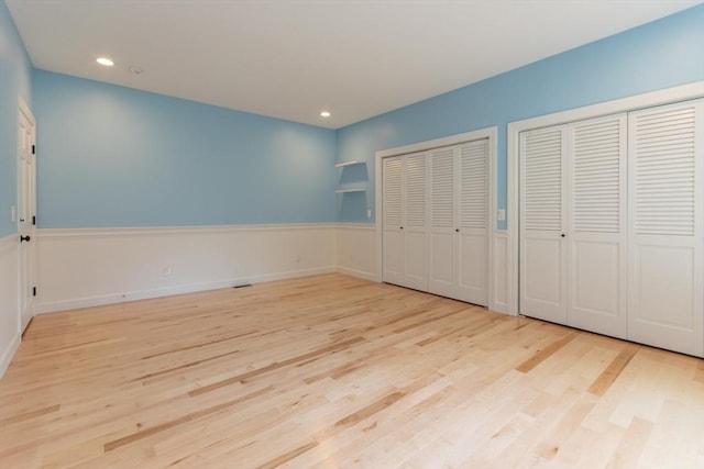 109 Wild Grove Ln, Longmeadow, MA 01106 - unfurnished bedroom featuring multiple closets, wood finished floors, and recessed lighting