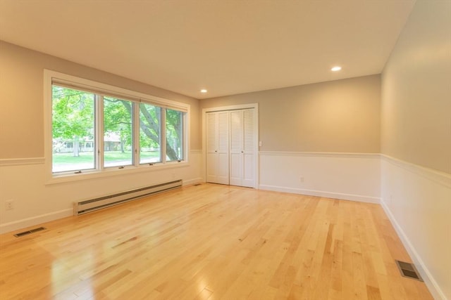 109 Wild Grove Ln, Longmeadow, MA 01106 - unfurnished bedroom with a baseboard heating unit, light wood-style floors, a closet, recessed lighting, and baseboards