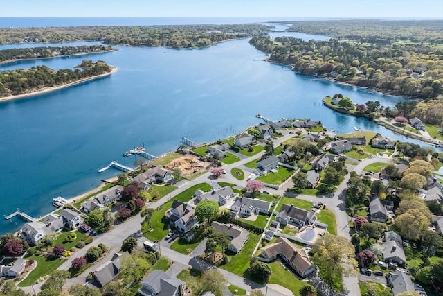 aerial view of property's location with a nearby body of water and nearby suburban area