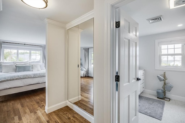 bathroom with ensuite bath, healthy amount of natural light, baseboards, and ornamental molding