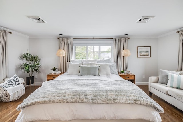 bedroom with ornamental molding, baseboards, and dark wood finished floors