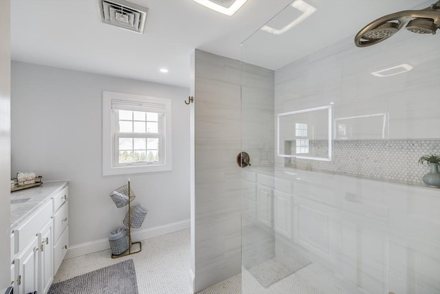 full bath featuring a walk in shower, baseboards, backsplash, recessed lighting, and vanity
