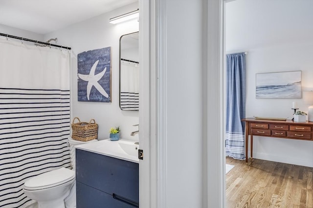 full bath with vanity, wood finished floors, and toilet