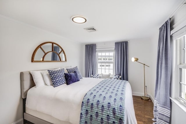 bedroom with dark wood-style floors and baseboards