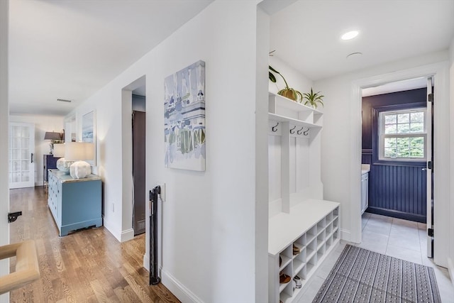 mudroom featuring baseboards and light wood finished floors