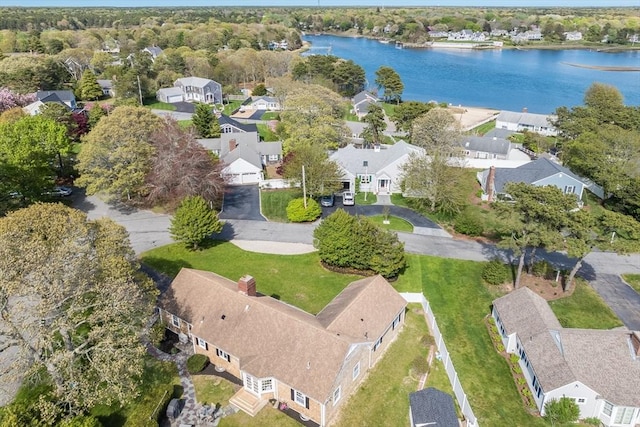 aerial view of property and surrounding area featuring nearby suburban area and a large body of water