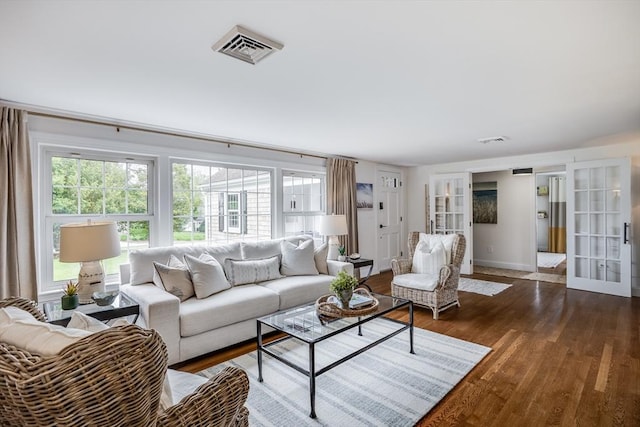 living room with french doors, wood finished floors, and baseboards