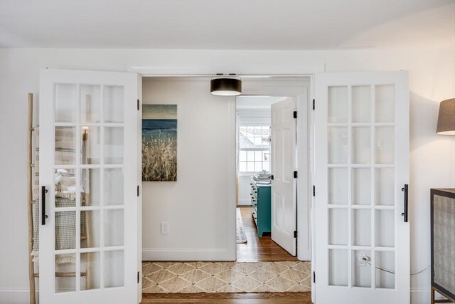 hall with wood finished floors and baseboards