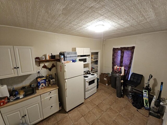 21 John, Worcester, MA 01609 - kitchen with light countertops, white cabinetry, ornamental molding, and white appliances