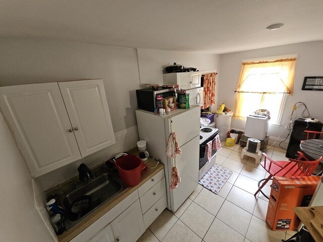 21 John, Worcester, MA 01609 - kitchen with white cabinets, a sink, white appliances, light countertops, and light tile patterned floors