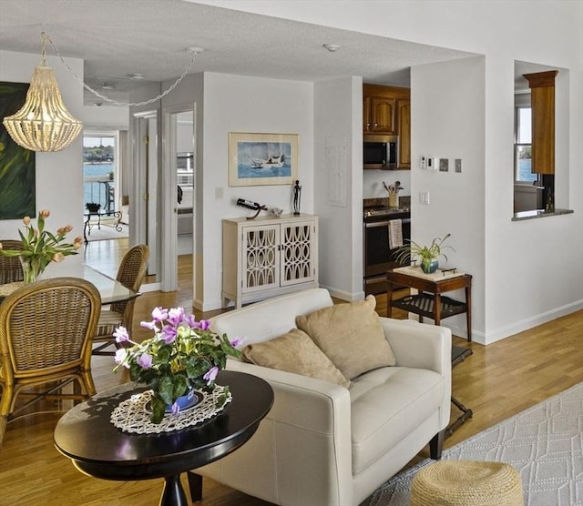 living area with light wood-style floors and baseboards