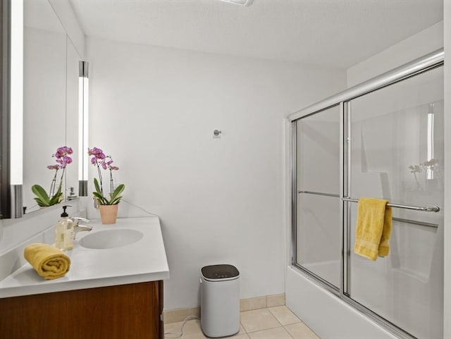 full bath with baseboards, tile patterned flooring, vanity, and shower / bath combination with glass door