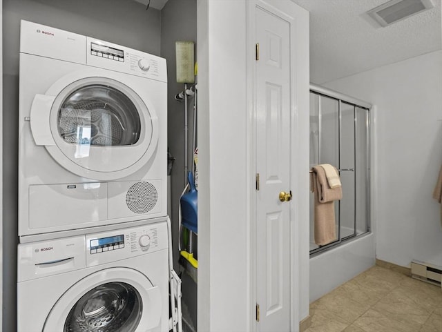 laundry room featuring laundry area, stacked washer / drying machine, visible vents, and a baseboard heating unit