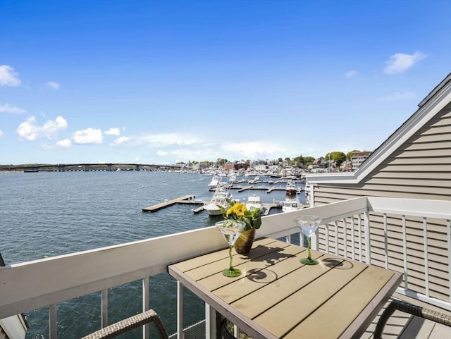balcony featuring a water view and a floating dock