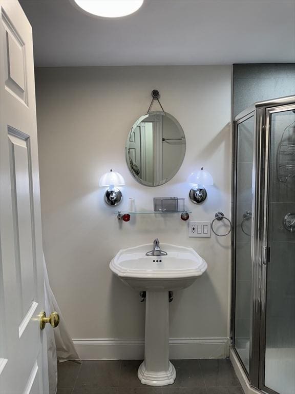 bathroom featuring tile patterned floors and a shower with shower door