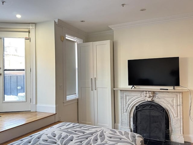 bedroom with crown molding and hardwood / wood-style flooring